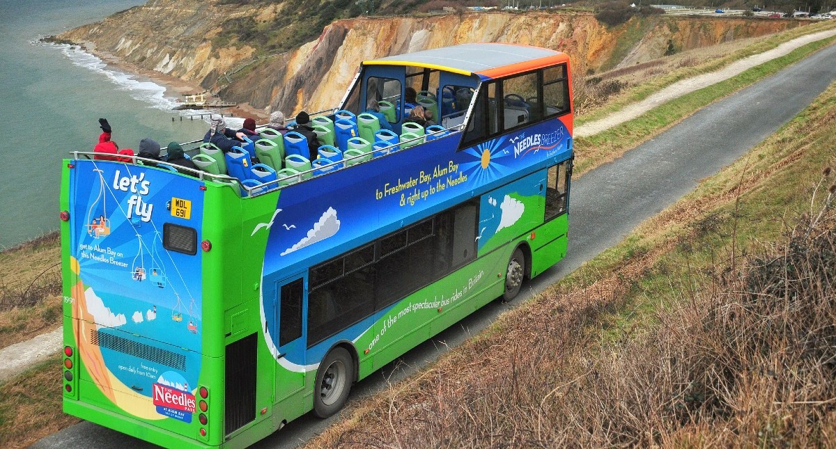 Open top bus travelling along the coast