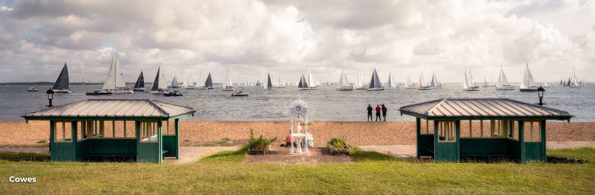 Cowes seafront with yachts sailing on the water around the Isle of Wight