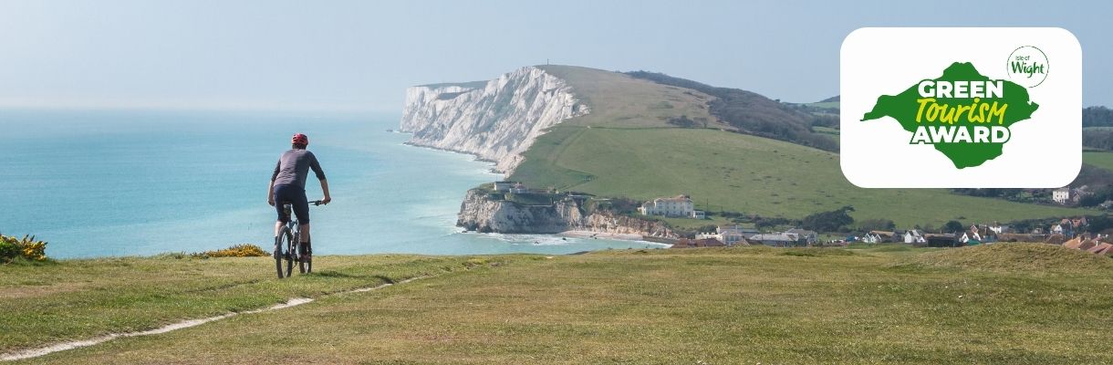 Cyclist riding along the cliff towards Freshwater, Isle of Wight