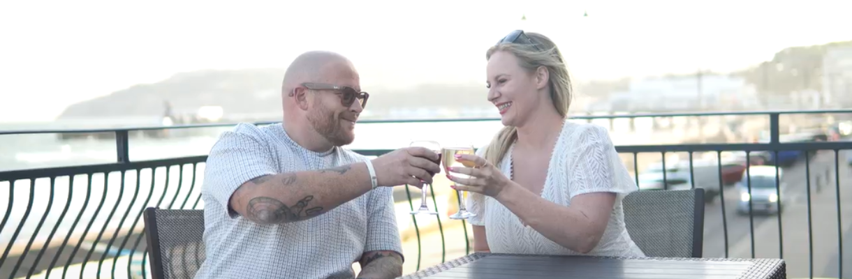 Couple enjoying an evening drink on the balcony at Sandringham Hotel on the Isle of Wight