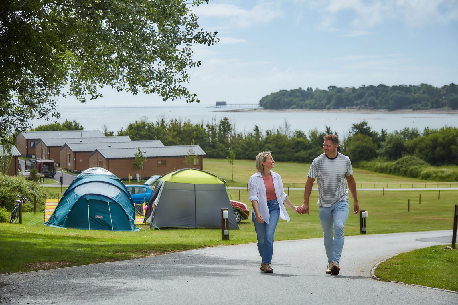 Couple walking through a campsite