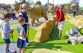 Family playing golf at Sandham Gardens